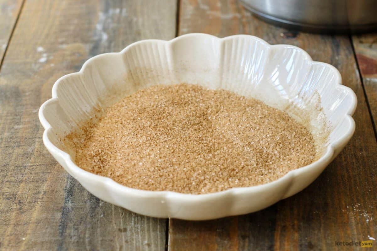 Granulated Erythritol mixed with ground cinnamon in a shallow plate