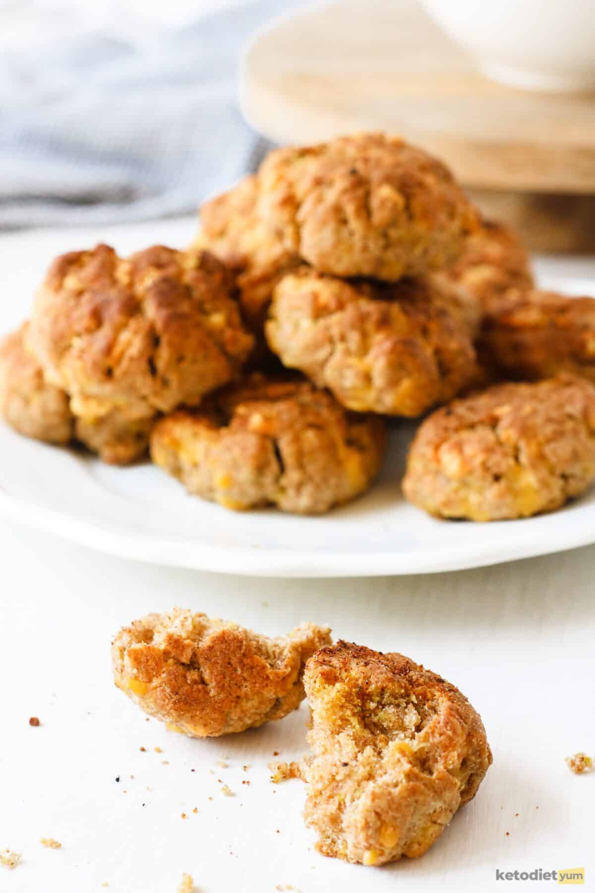 Crispy golden keto cheddar biscuits with a melt in your mouth cheesy inside ready to enjoy