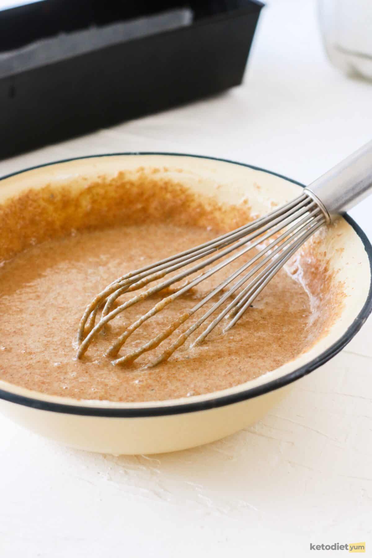 Combining the wet ingredients and dry ingredients in a mixing bowl to form a cake batter