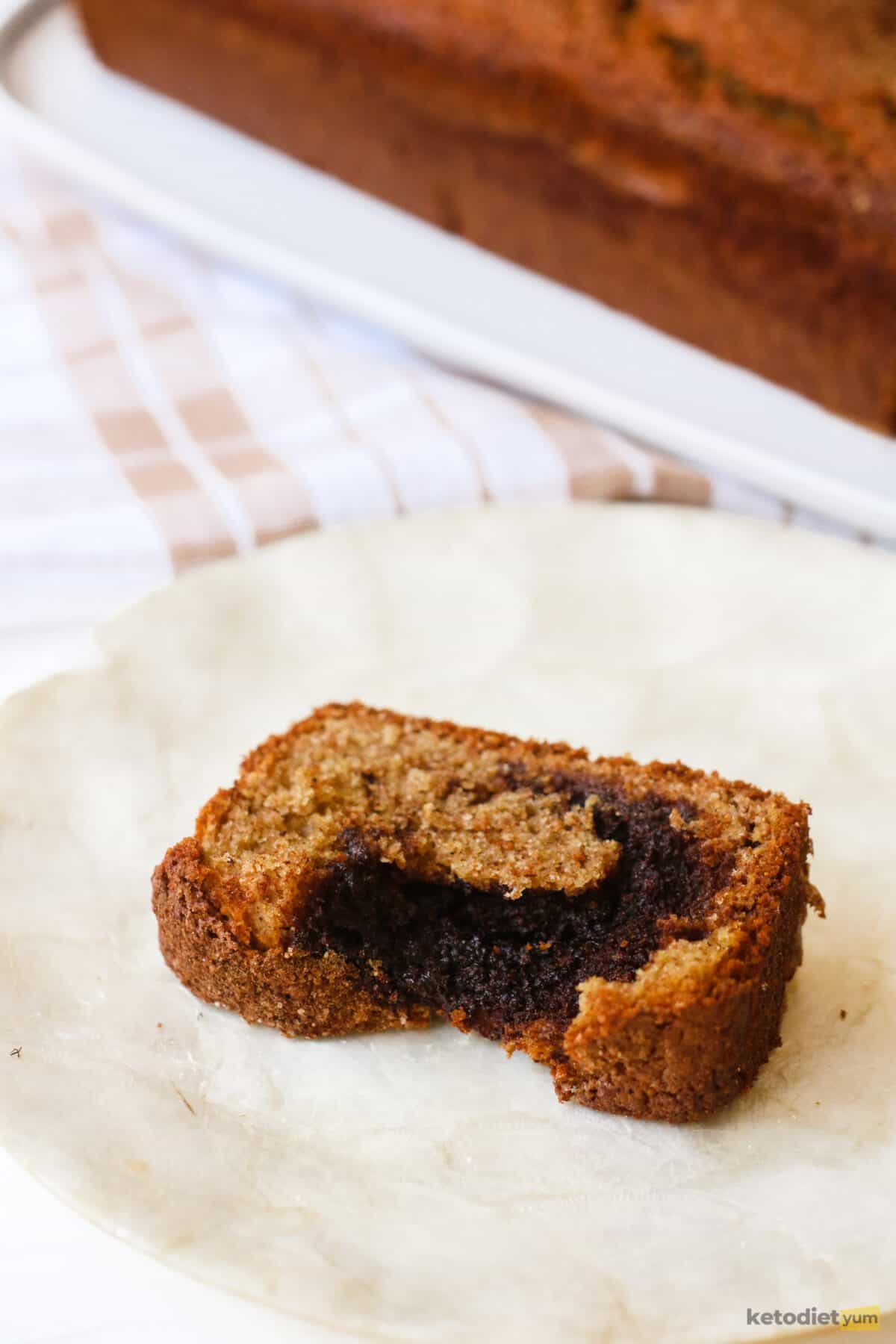 A slice of keto cinnamon swirl cake on a white plate ready to enjoy