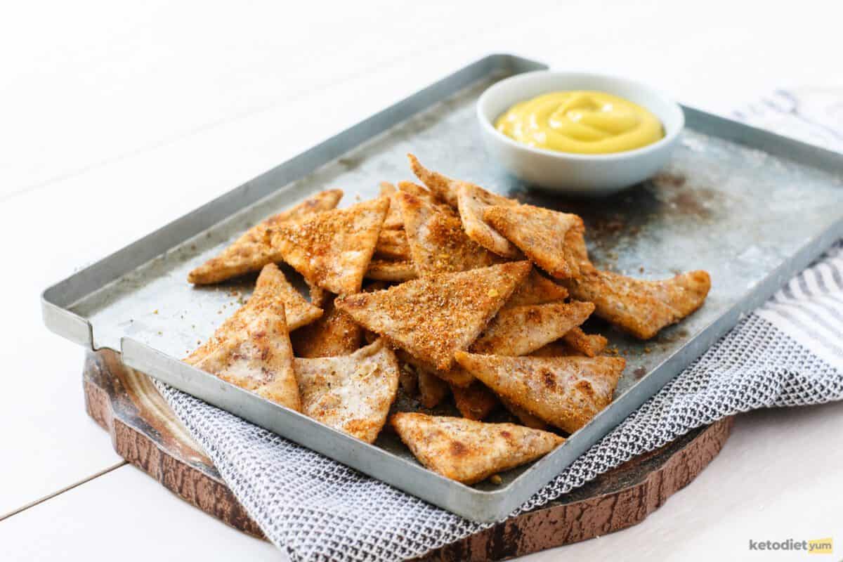 Keto Doritos on a baking tray served with a low carb dip