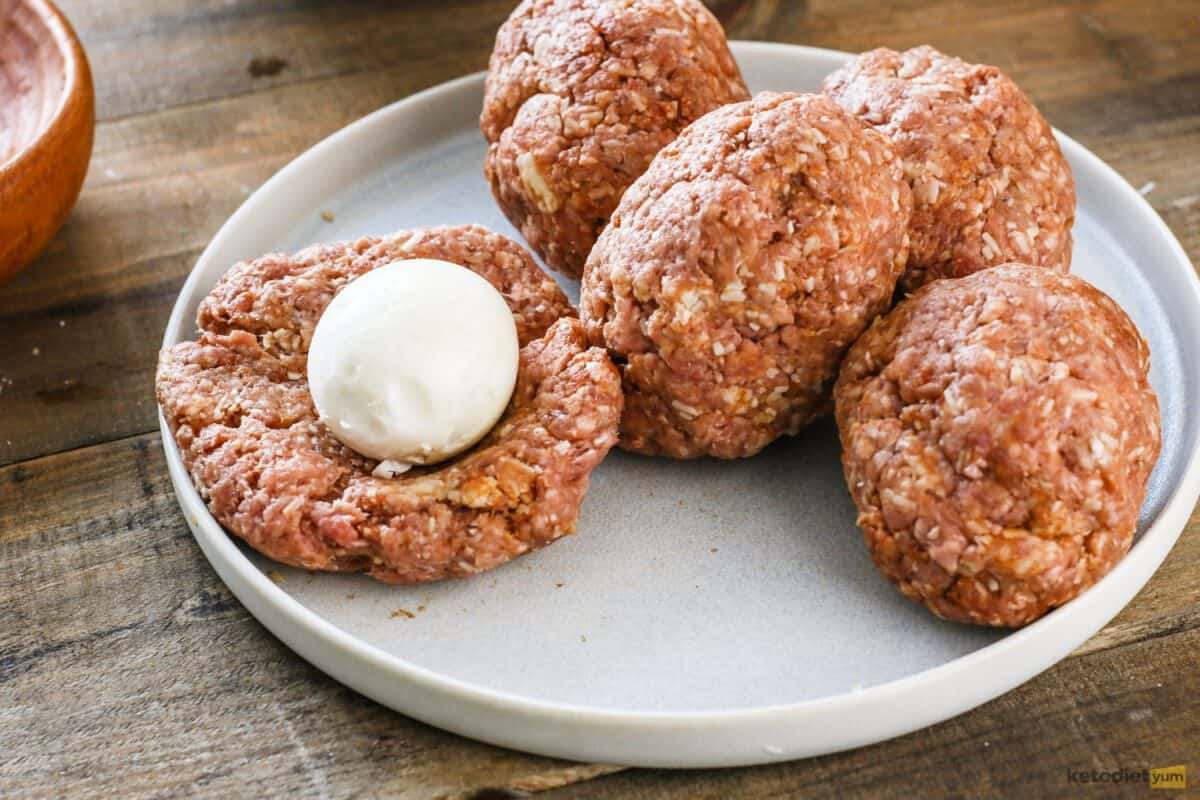 Keto Scotch Eggs Hard boiled eggs wrapped in a ground pork cheese mixture ready to bake