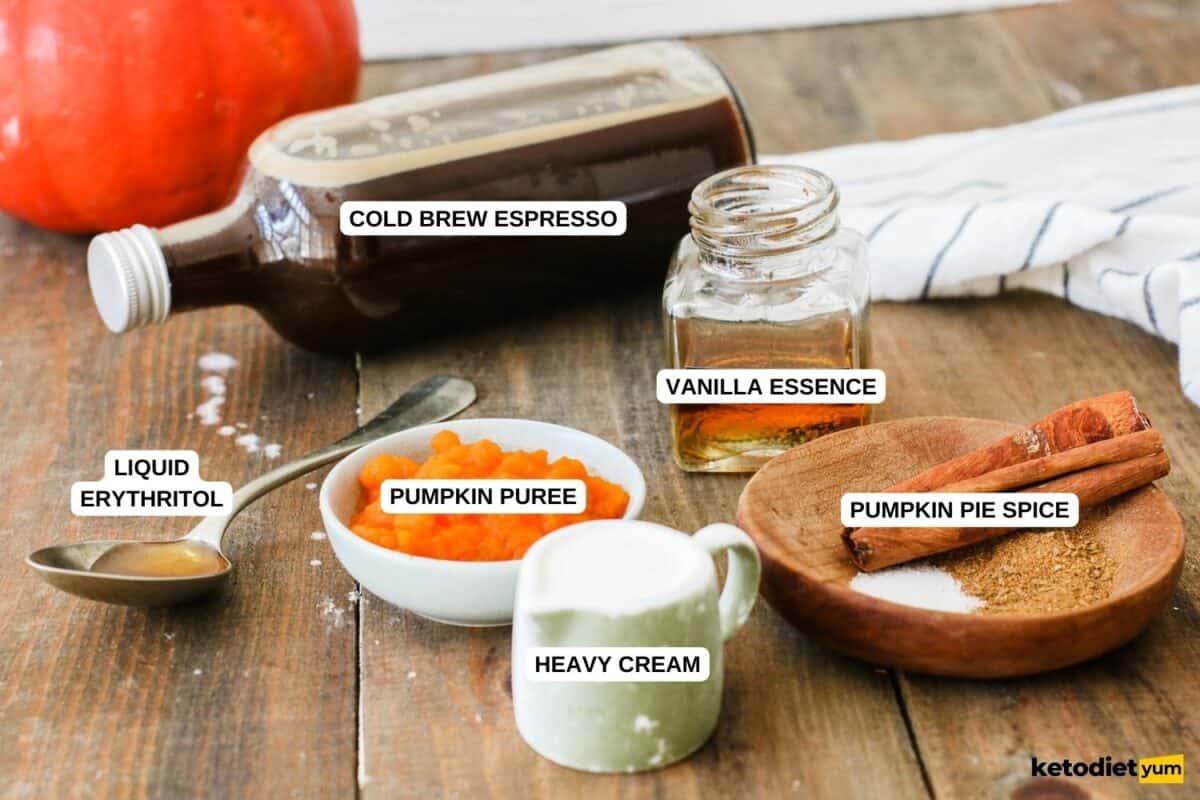 Ingredients arranged on a table to make Starbucks pumpkin spice cold brew including espresso, pumpkin puree, pumpkin spice, Erythritol, heavy cream and vanilla essence