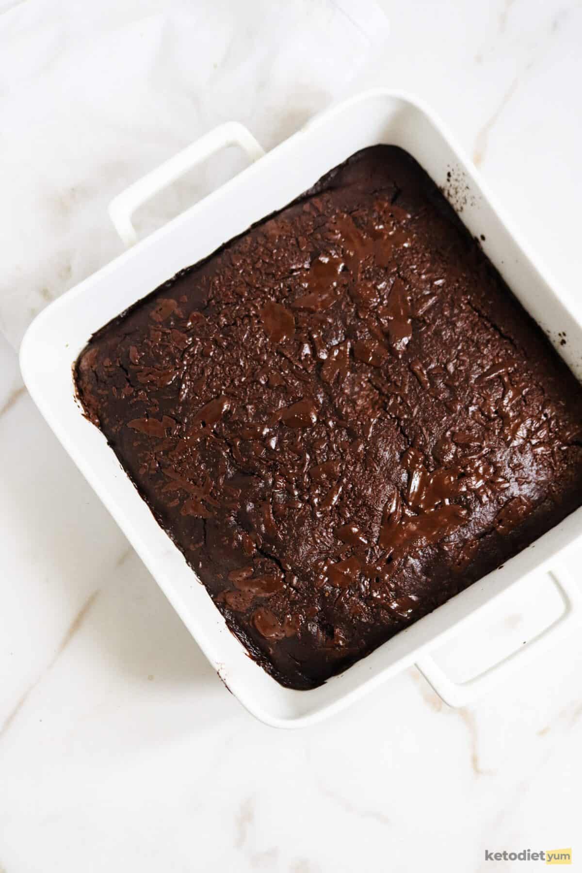 Baking pan with baked avocado brownie resting on a table