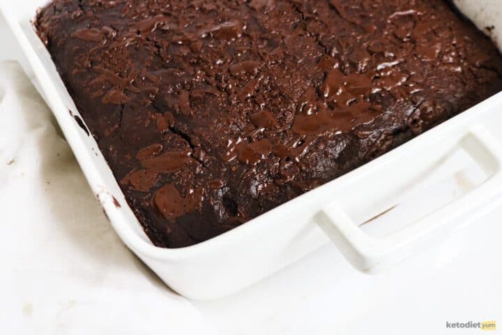 Baking pan with avocado brownie fresh out of the oven resting on a table