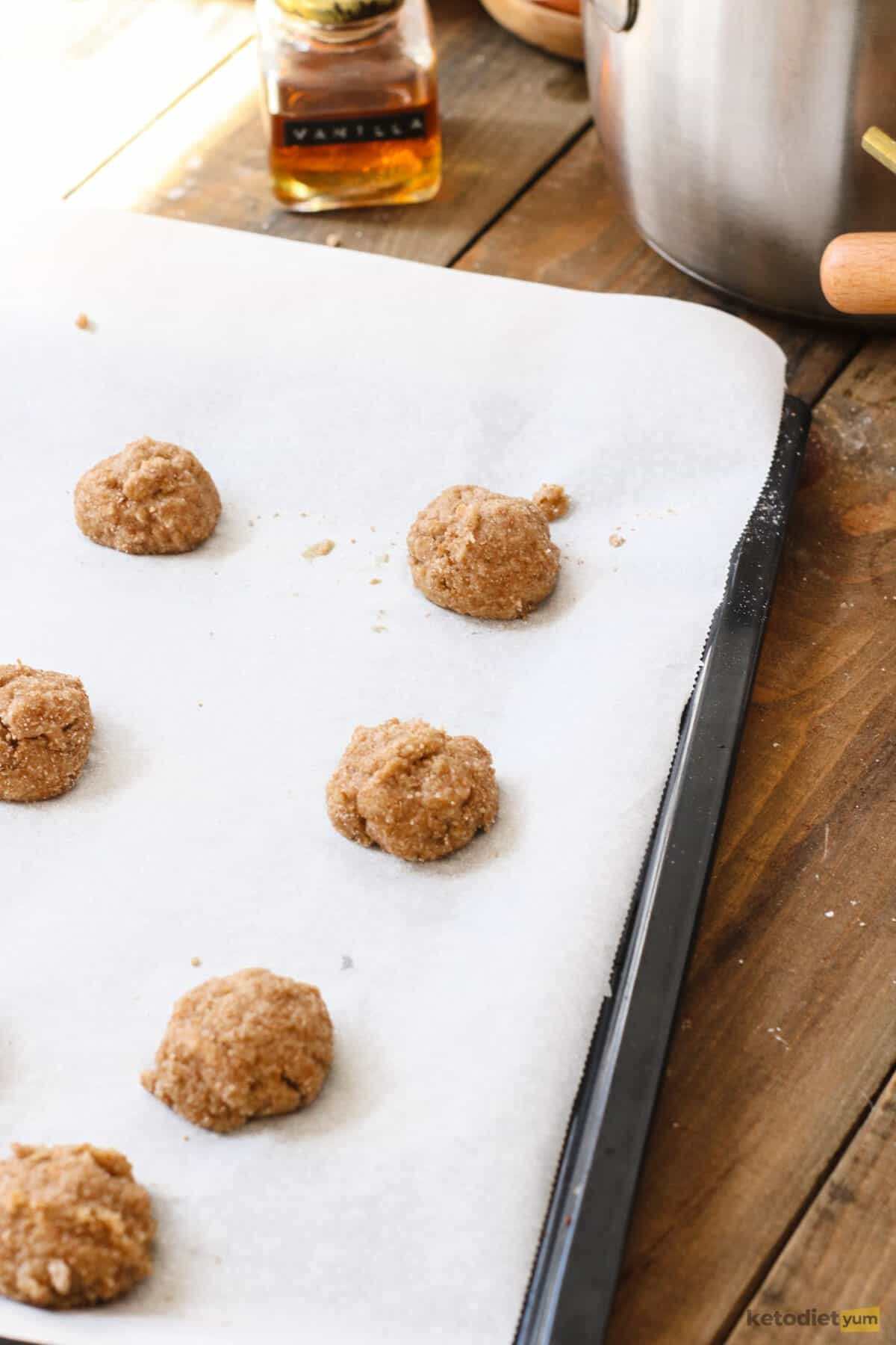 Donut balls on a lined baking pan
