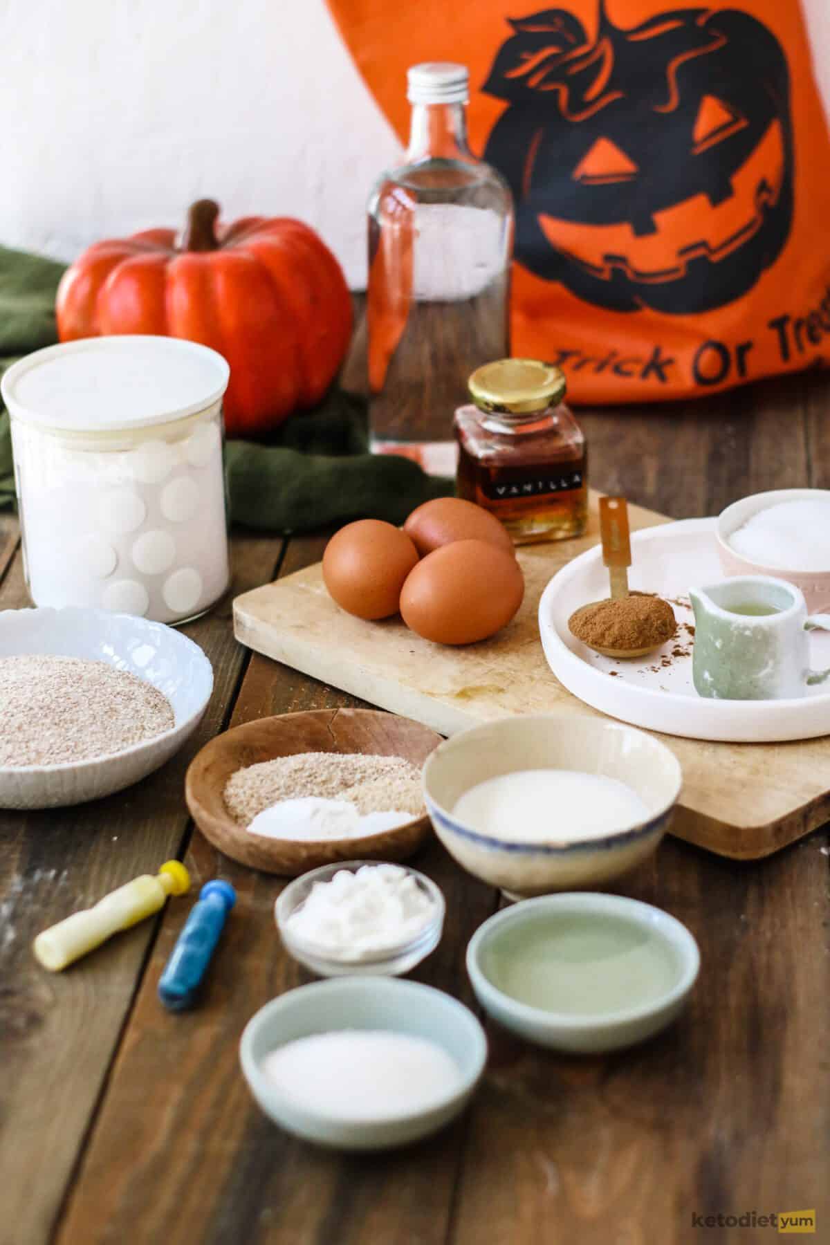 Plates, bowls and a chopping board with ingredients on a table with Halloween decorations