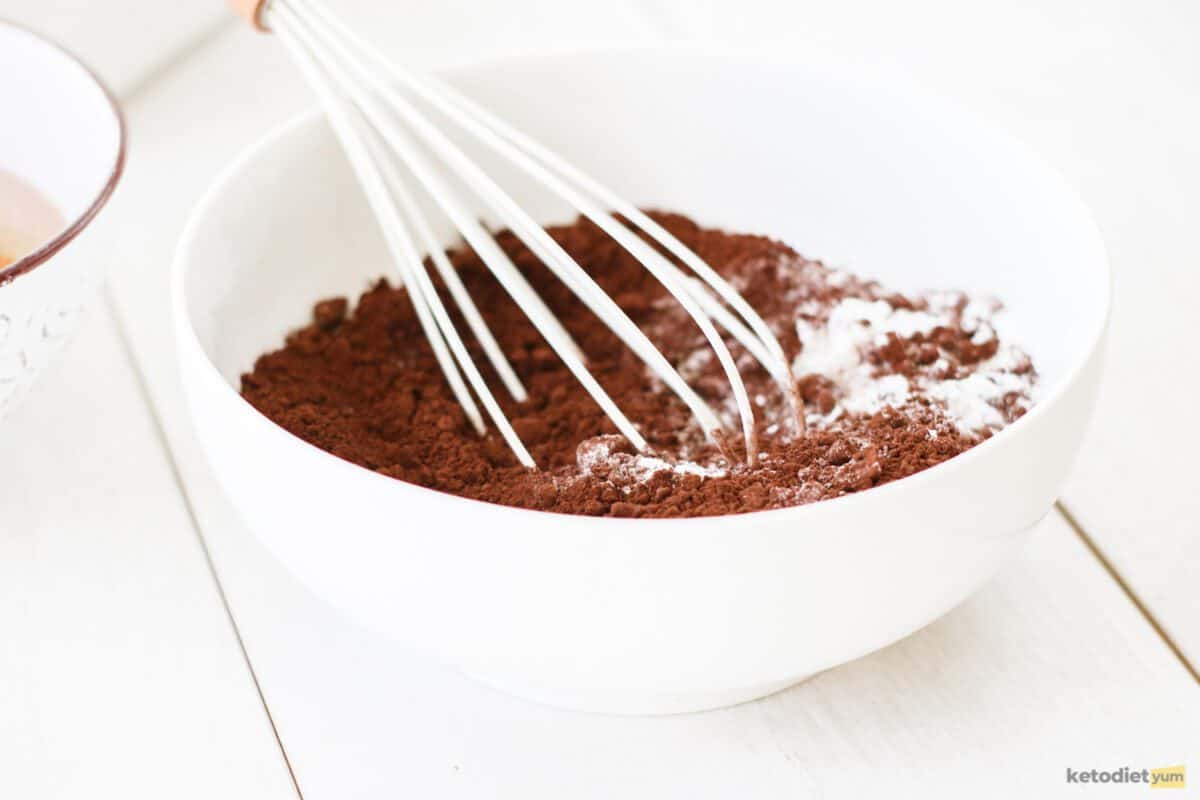 Dry ingredients in a white bowl with a whisk