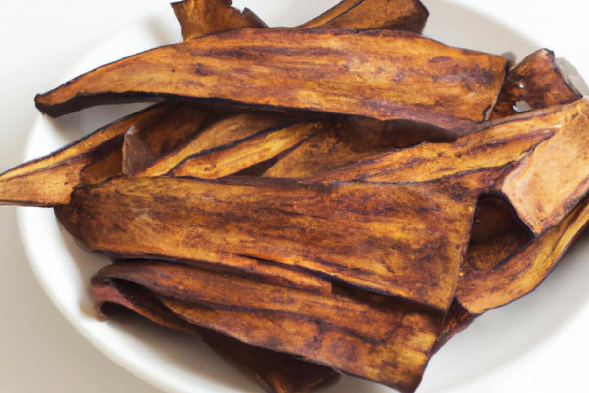 A bowl of eggplant bacon made by baking eggplant strips with olive oil and seasonings