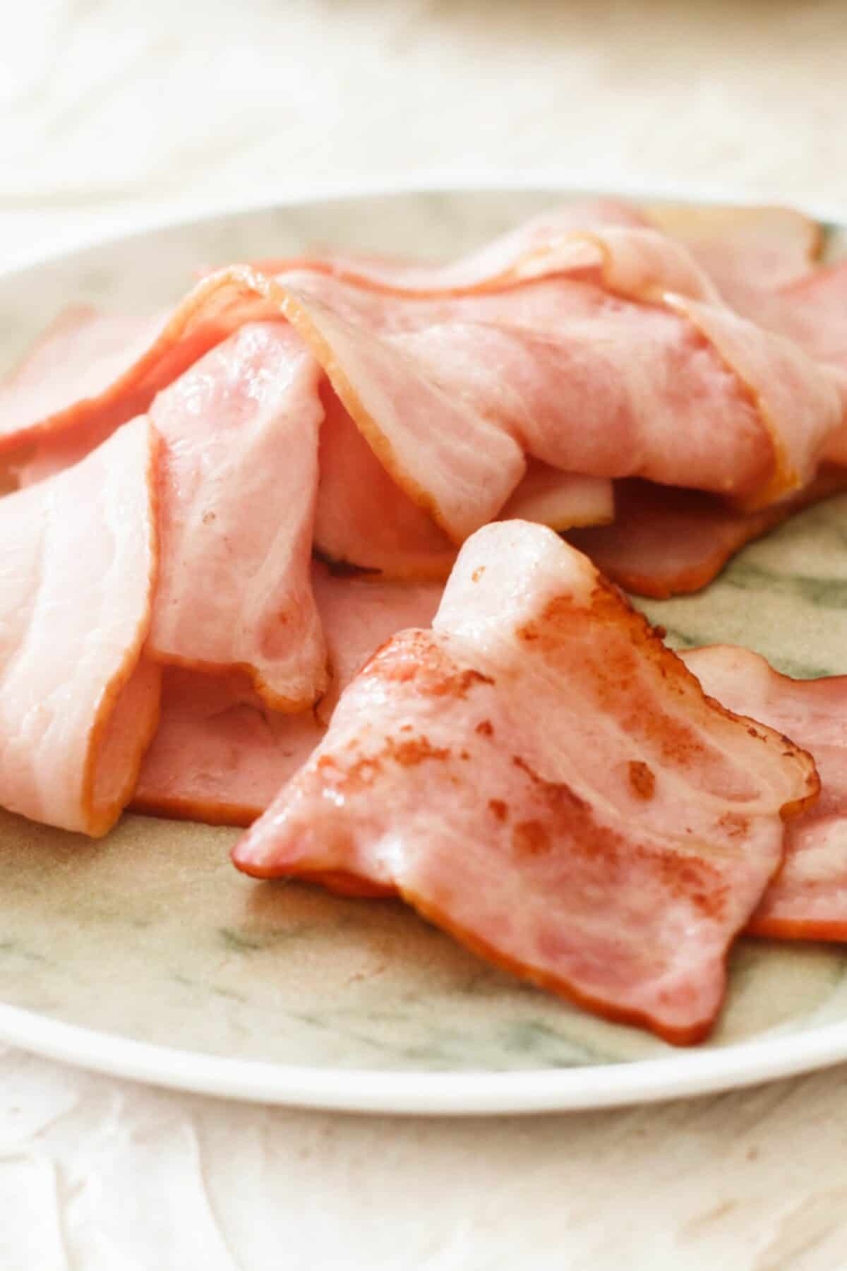 Golden crispy bacon slices on a plate