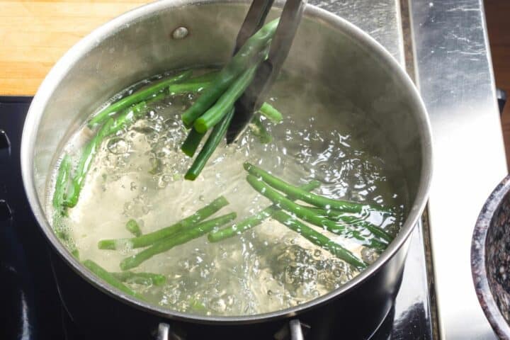 Blanching green beans in a pot of boiling water