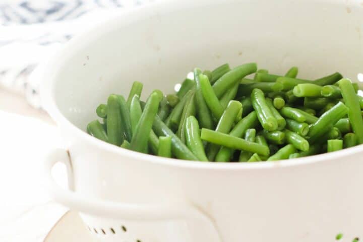 Green beans drained in a plastic colander