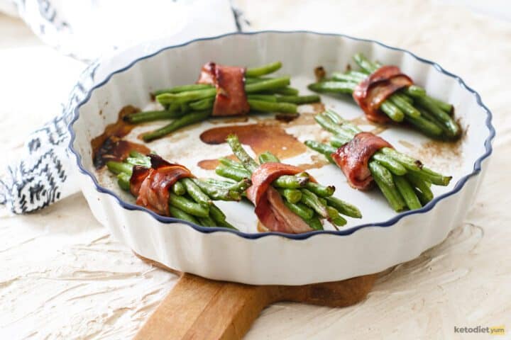 Bacon wrapped green beans baked to perfection in a baking dish
