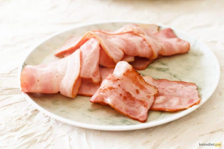 Golden crispy bacon slices on a plate