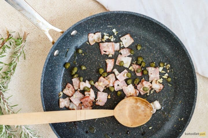 Frying bacon, capers and garlic in olive oil