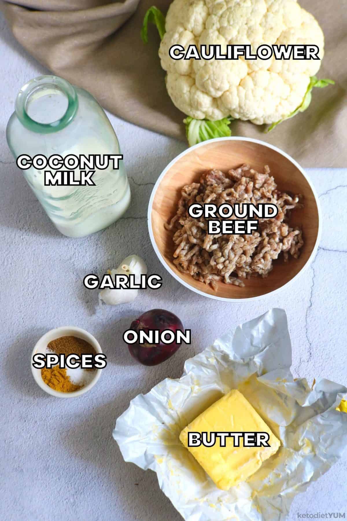 Ingredients needed to make a keto curry including ground beef, cauliflower, ghee, coconut milk, garlic, onion and spices