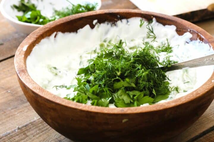 making tzatziki sauce in a bowl