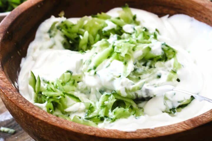 making tzatziki sauce in a bowl