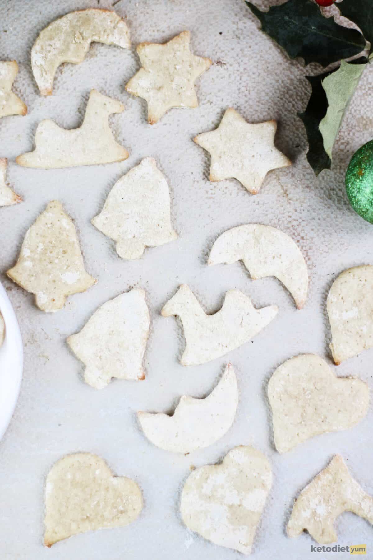 sugar free cookies - keto sugar cookies cut into Christmas shapes on a table