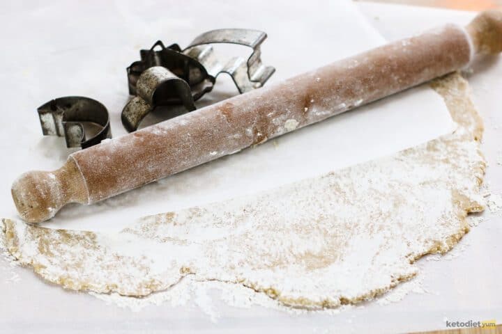 gluten free sugar cookies - rolling dough into a sheet between baking paper