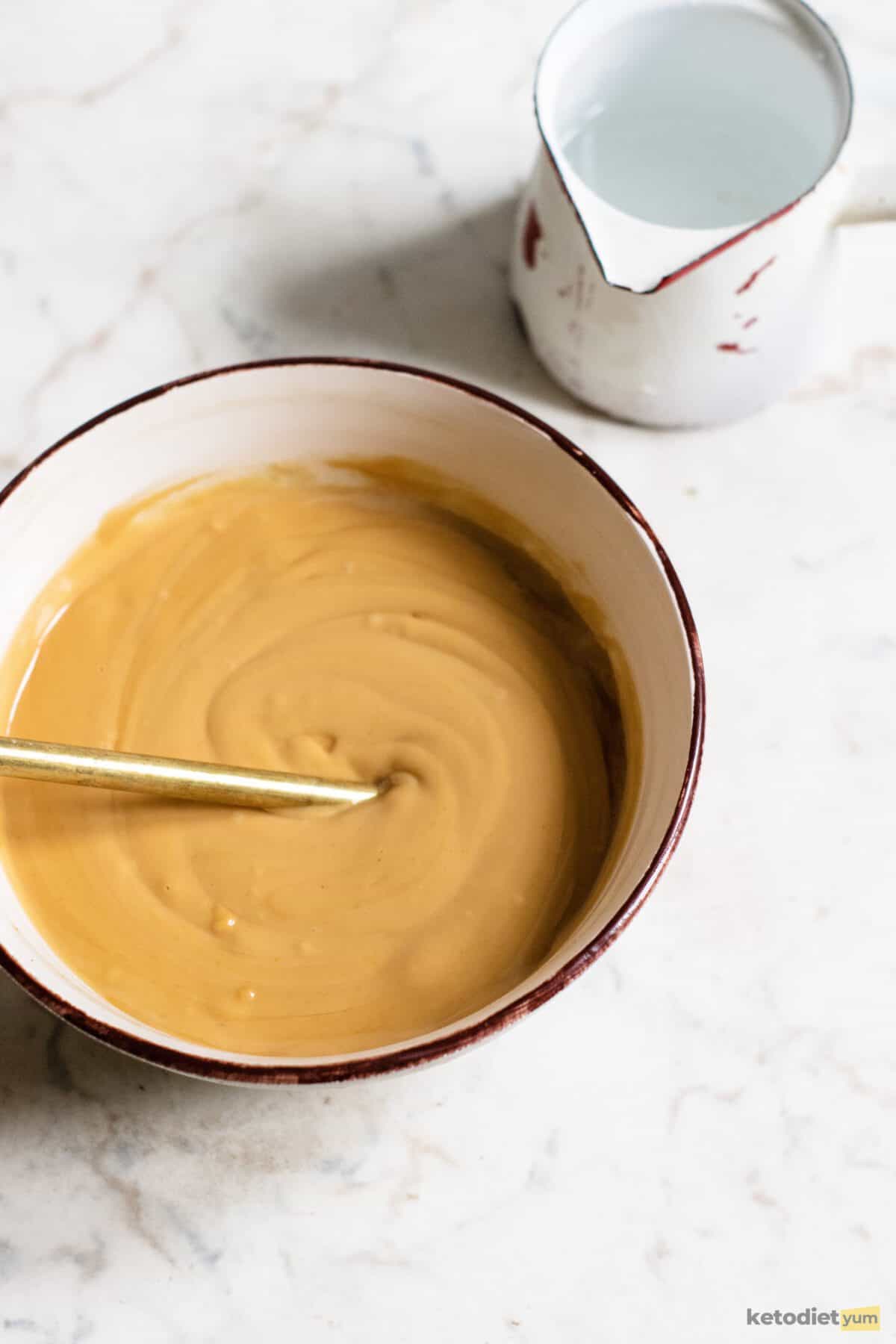 keto peanut sauce - mixing ingredients in a bowl