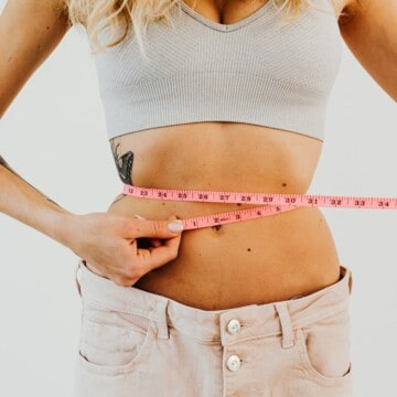 woman measuring waistline