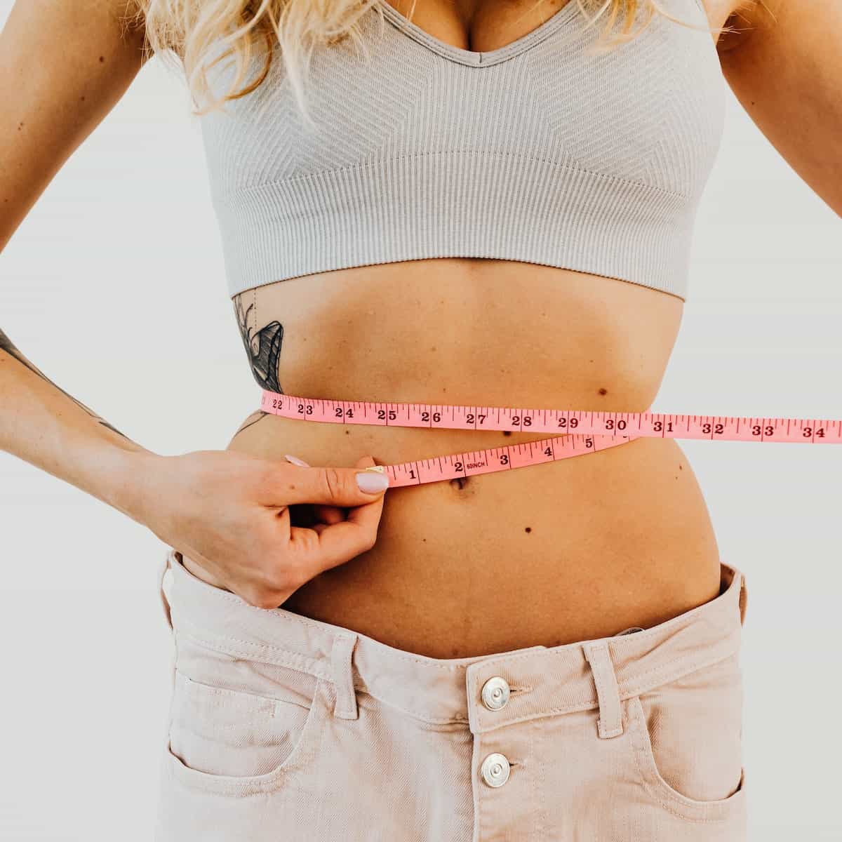 woman measuring waistline