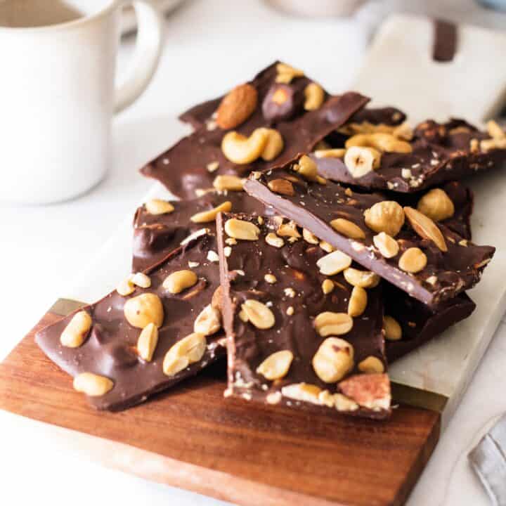 Chocolate bark with nuts and nuts on a cutting board