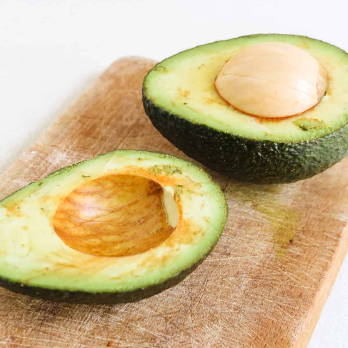 Sliced avocado on a wooden cooking board