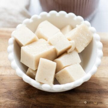 Close-up of soft, sugar-free keto marshmallows made with gelatin and vanilla protein shake, cut into cubes and served in a white bowl