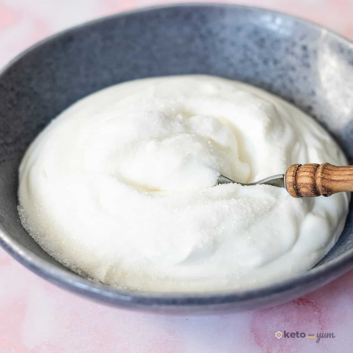 3 Ingredient Frozen Yogurt Bites Bowl of unsweetened coconut-flavored Greek yogurt mixed with sugar-free sweetener to make creamy frozen Greek yogurt bites.